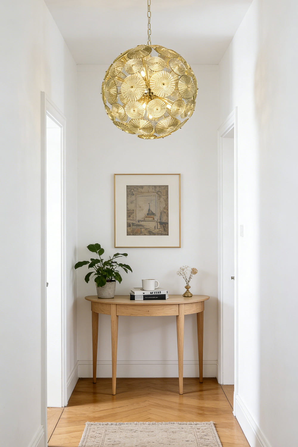 Lit modern classic spheres chandelier | Metal, Glass | Installed at the end of a corridor over a console table | vexalamps