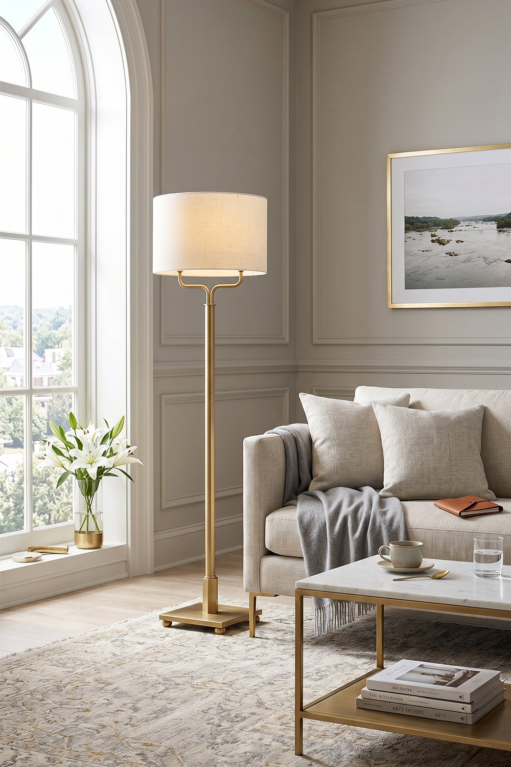 Sutton Modern Brass Floor Lamp illuminating a cozy living room with elegant decor and natural light.