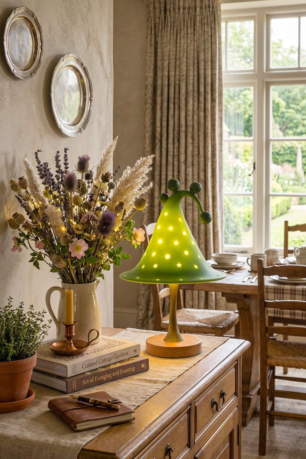 Sylvan Astral Resin Table Lamp | Green star pattern shade | Lit dining room scene | Sideboard display | Surrounded by plants | vexa lamps