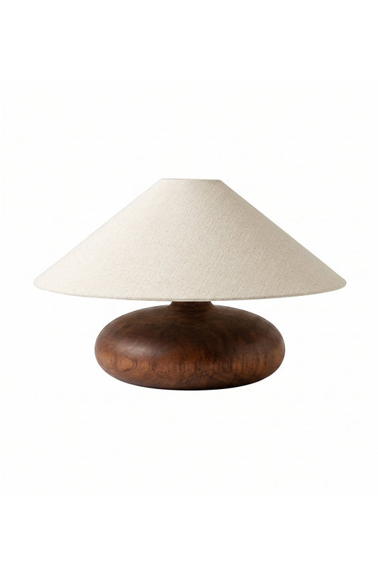 Sylvan Oval Walnut Table Lamp | Wood, Fabric, Metal | Low-profile table lamp with a wide conical beige fabric shade and a smooth oval walnut wood base | Isolated lit product shot on white background | vexa lamps