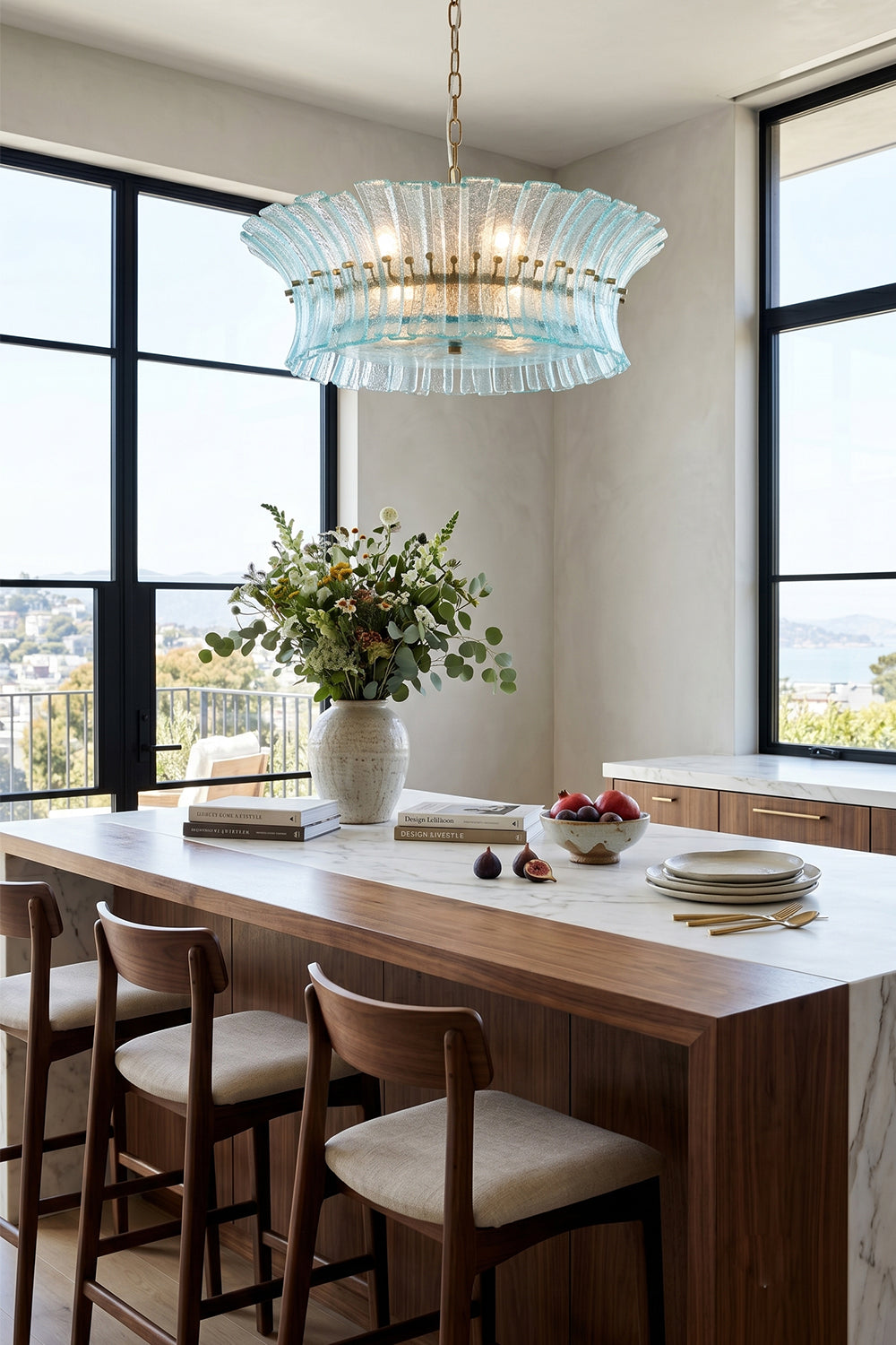 Thalassa Aquamarine Textured Glass Chandelier | Glass, Metal | Suspended gracefully above a long wooden dining table set with modern chairs in a spacious room with floor-to-ceiling windows | vexa lamps