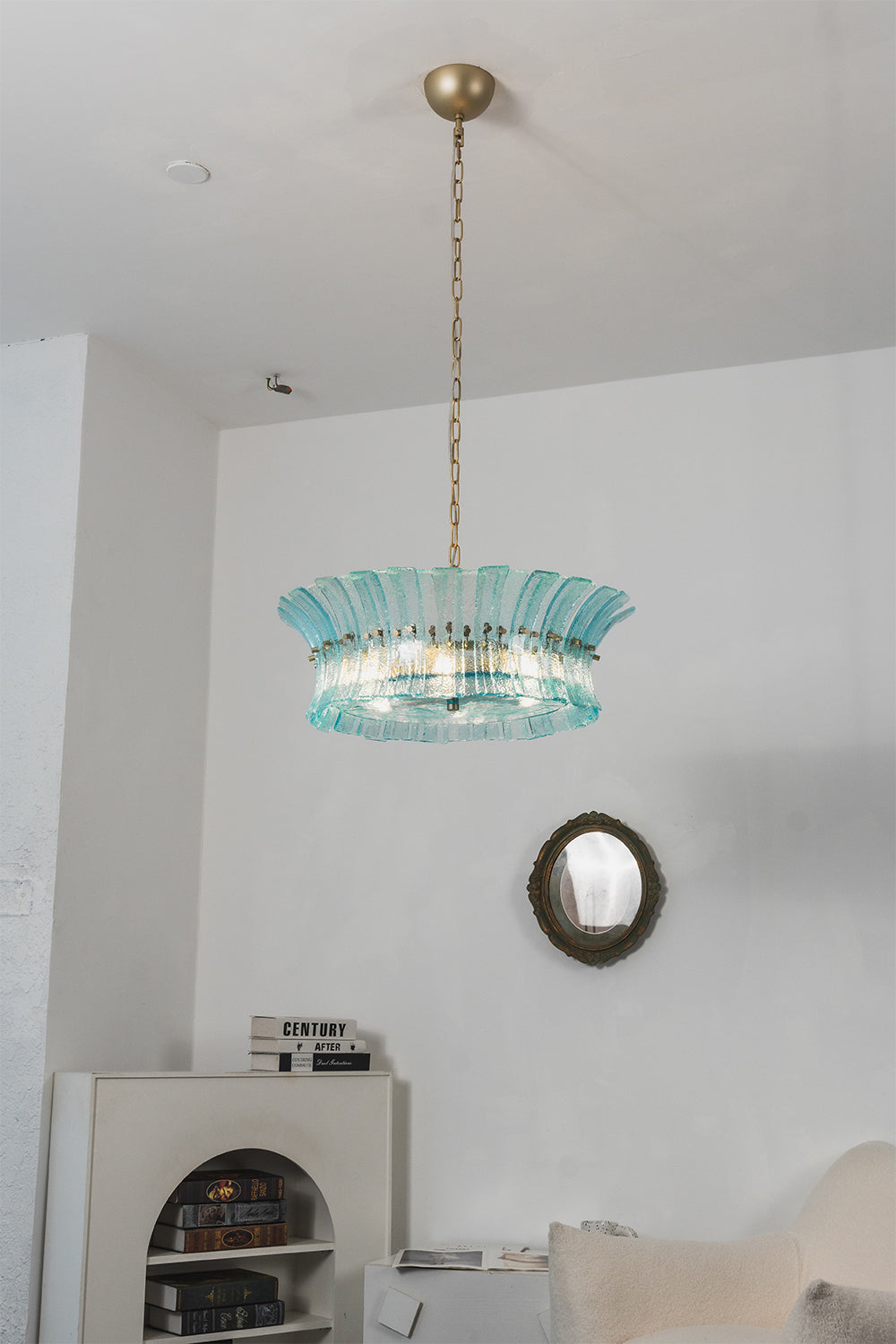 Thalassa Aquamarine Textured Glass Chandelier | Glass, Metal | Clean studio frontal view of the fully illuminated tiered ocean blue glass pendant hanging gracefully against plain white walls | vexa lamps