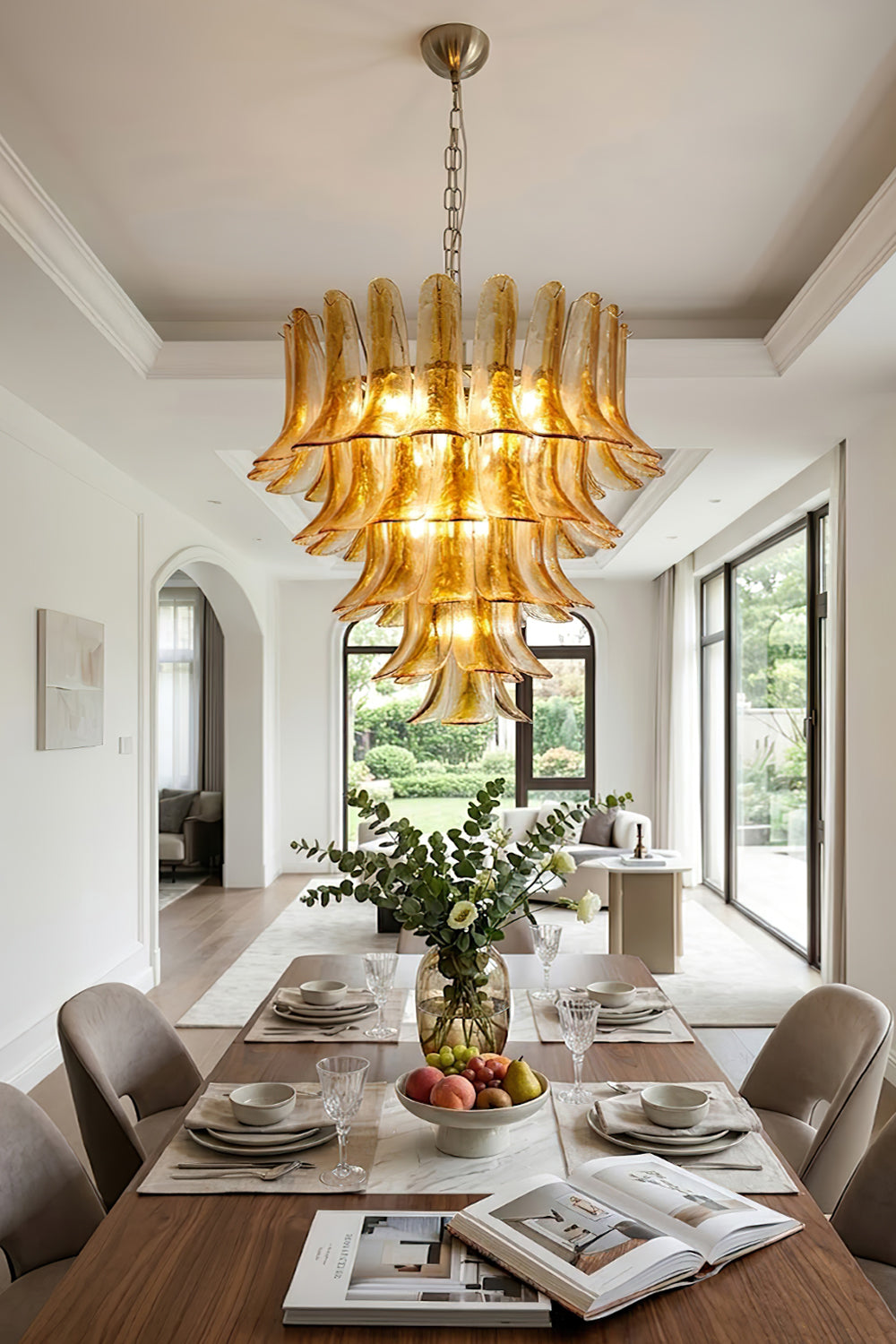 Lit amber lily glass chandelier over dining set | Metal, Glass | Traditional dining room interior with magazines and plants | vexa lamps