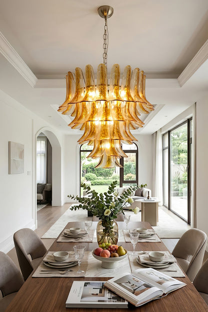 Lit amber lily glass chandelier over dining set | Metal, Glass | Traditional dining room interior with magazines and plants | vexa lamps