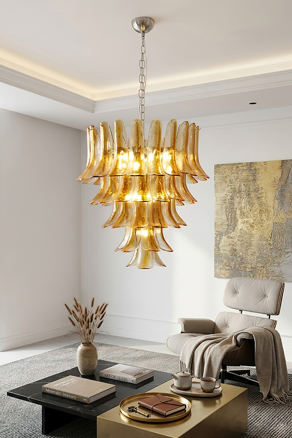 Tiered amber glass chandelier in living room | Metal, Glass | Interior scene with grey armchair and marble coffee table | vexa lamps