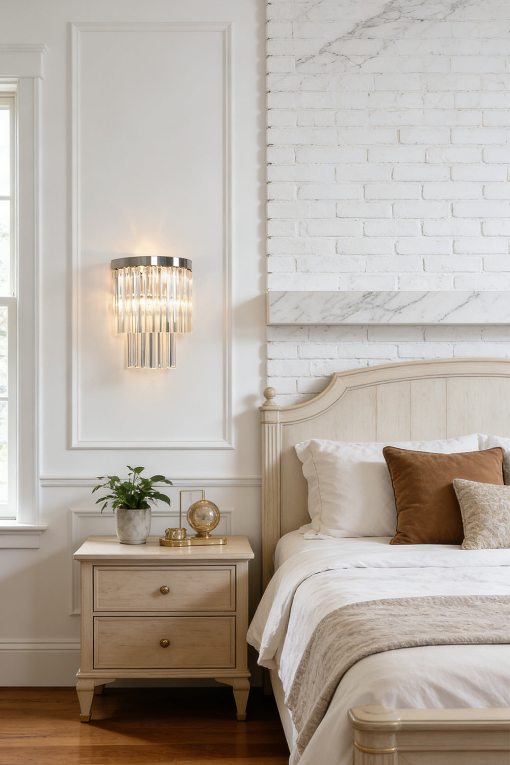 Lit tiered column glass wall light | Metal, Glass | Installed on a classic white wall over a bedside nightstand | vexalamps