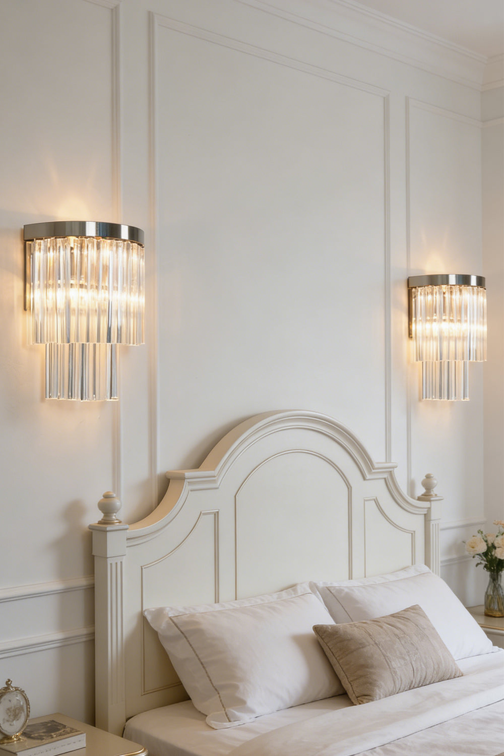 Lit tiered column glass wall light | Metal, Glass | Installed on a classic white wall over a bedside nightstand | vexalamps