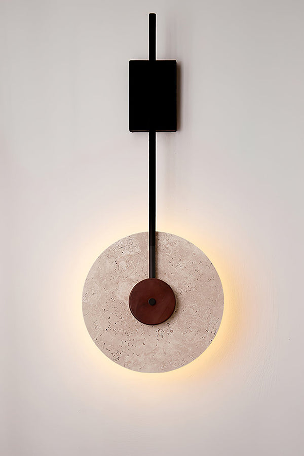 Lit travertine halo wall sconce close-up | Travertine, Wood, Metal | Showing the warm light ring and black hardware | vexa lamps