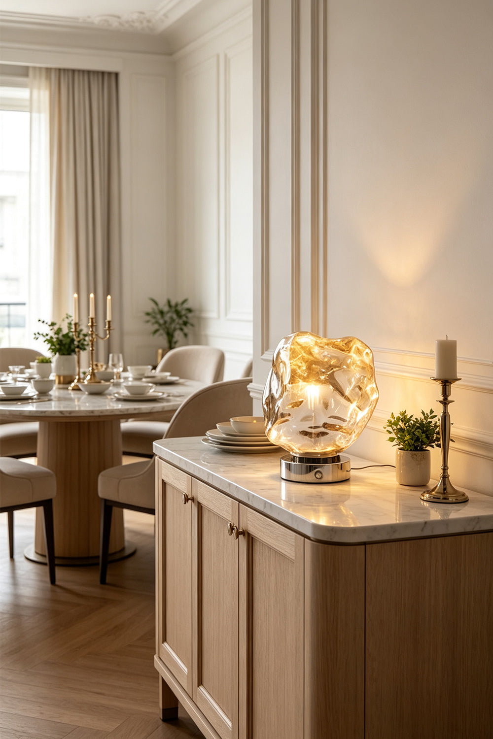 Vega Molten Metal Table Lamp illuminating a stylish dining area with elegant decor and furniture.