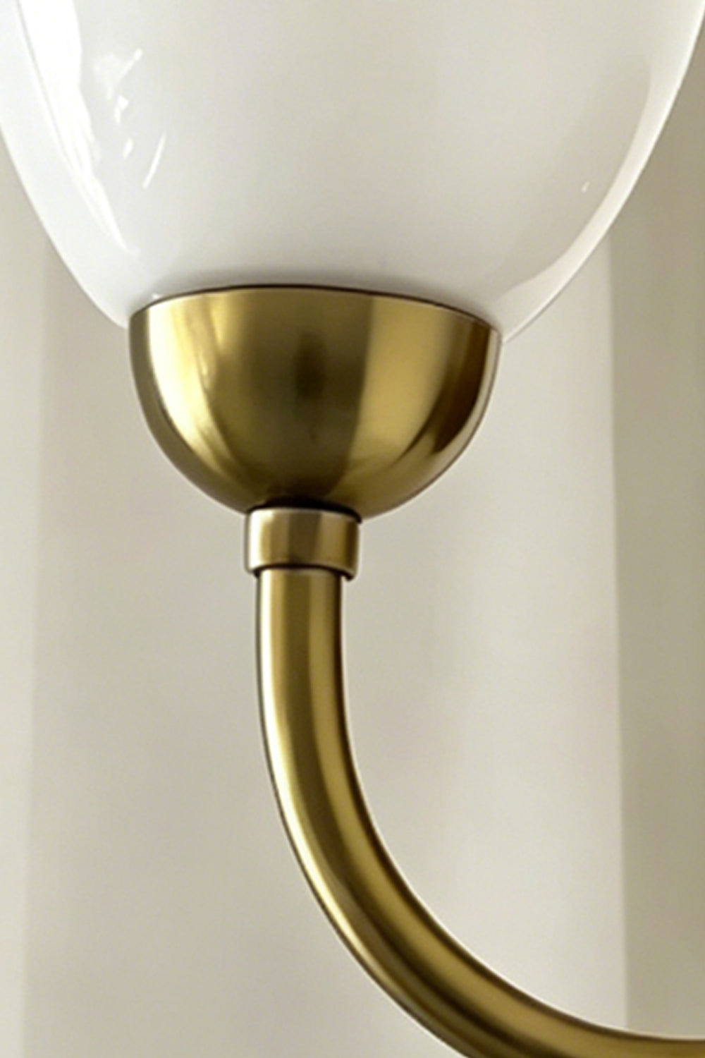 Close-up of Veil Curve Glass Wall Lamp | Metal, Glass | Detail shot focusing on brass base and opaque white glass shade | vexa lamps