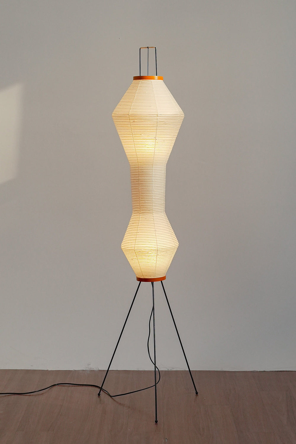 Verena Hourglass Paper Floor Lamp with soft pleated shade and slim black metal base.