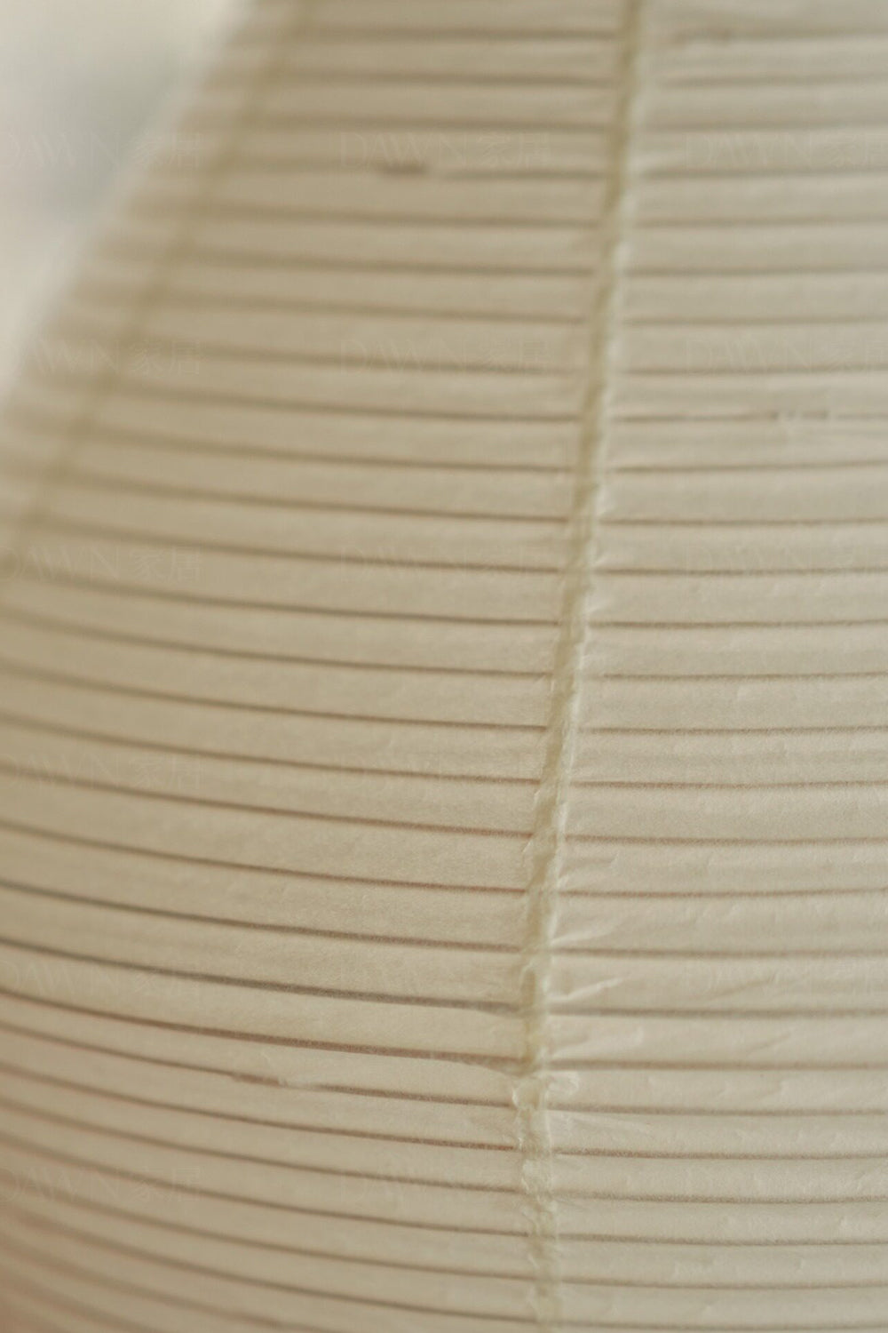 Close-up of the pleated paper shade of the Verena Hourglass Paper Floor Lamp, showcasing its texture and design.