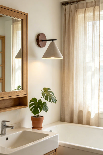 Vesper Cone Travertine Wall Light | Travertine, Wood | Bathroom vanity lighting next to wooden cabinet | vexa lamps