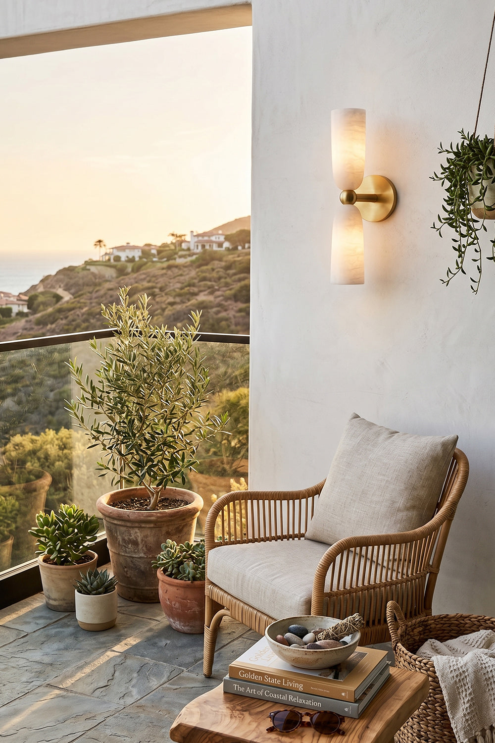 Vesperal Axis Alabaster Wall Lamp | Alabaster, Metal | Illuminating a scenic balcony at sunset with a rattan chair and potted plants | vexa lamps